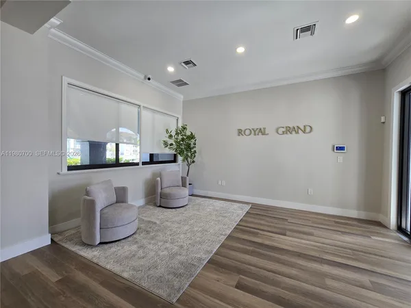 a room with wooden floor and white walls