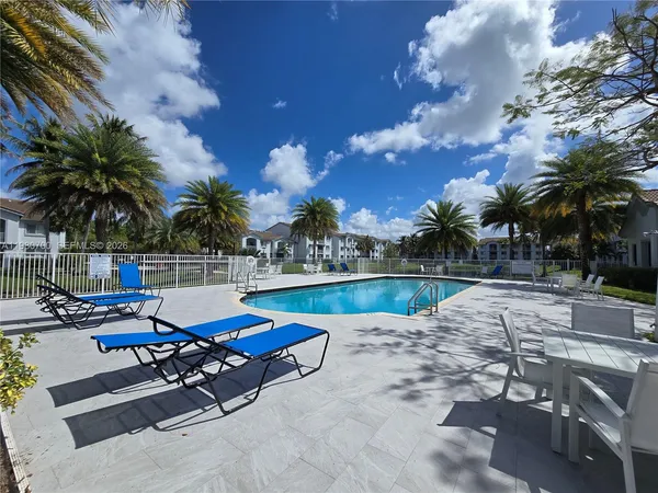 a view of swimming pool with outdoor seating and plants