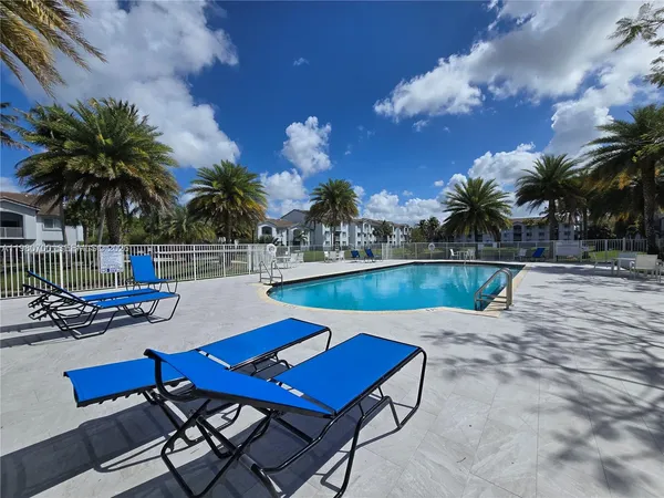 a view of a swimming pool with lounge chairs
