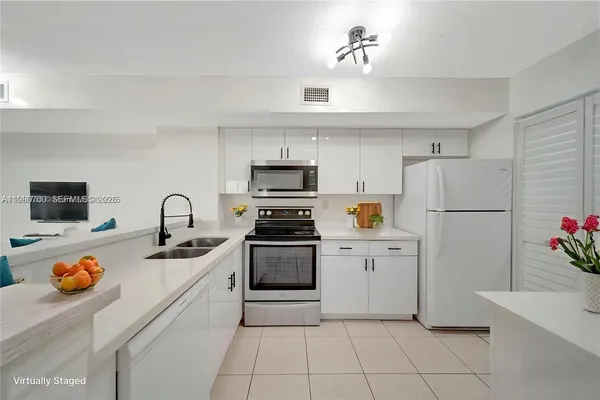 a kitchen with cabinets and white appliances
