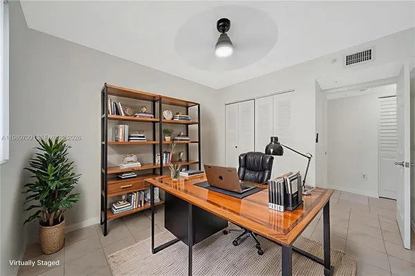 a work room with furniture and a potted plant