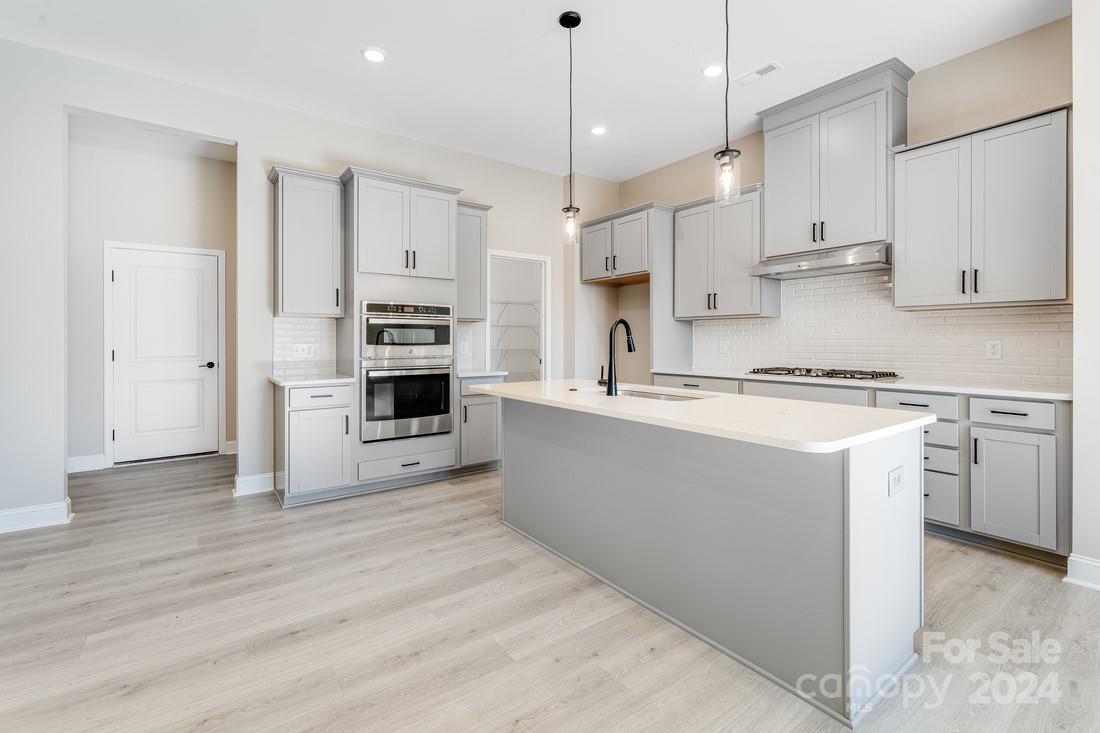 1158 Lost Cv Road Indian Land, SC 29707 - Photo 1 of 19 a kitchen with kitchen island a stove a sink and a refrigerator