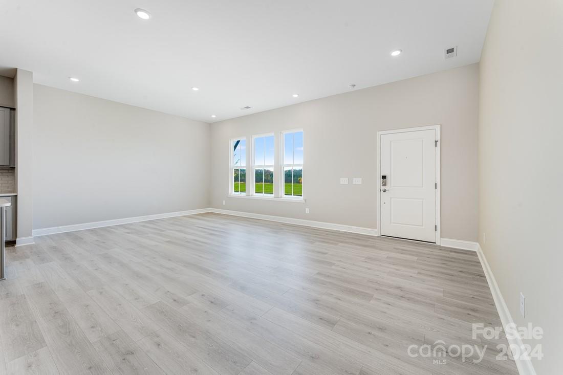 1158 Lost Cv Road Indian Land, SC 29707 - Photo 6 of 19 an empty room with wooden floor and windows