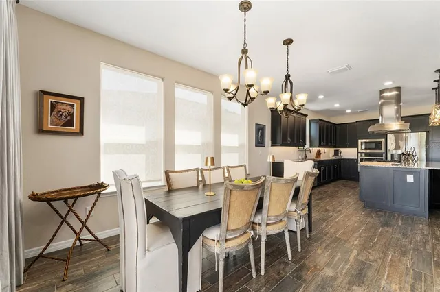 a bathroom with a granite countertop double vanity sink mirror and shower