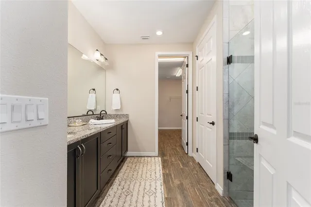 a bathroom with a granite countertop sink toilet and a bathtub