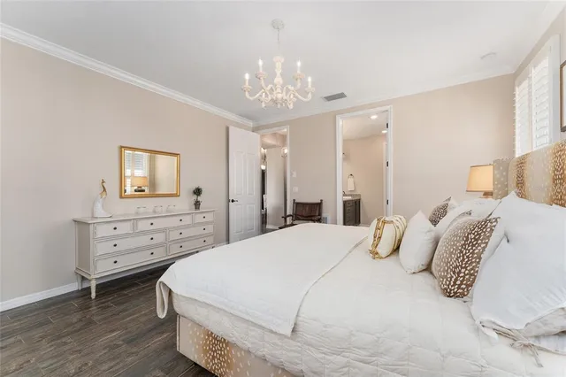 a bedroom with two beds and painting on the wall