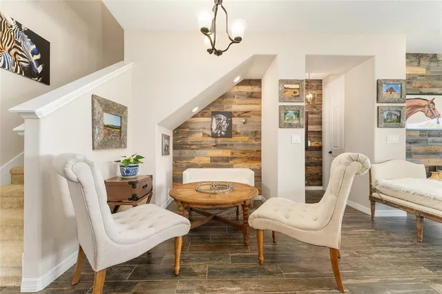 a kitchen with counter top dining table and chairs