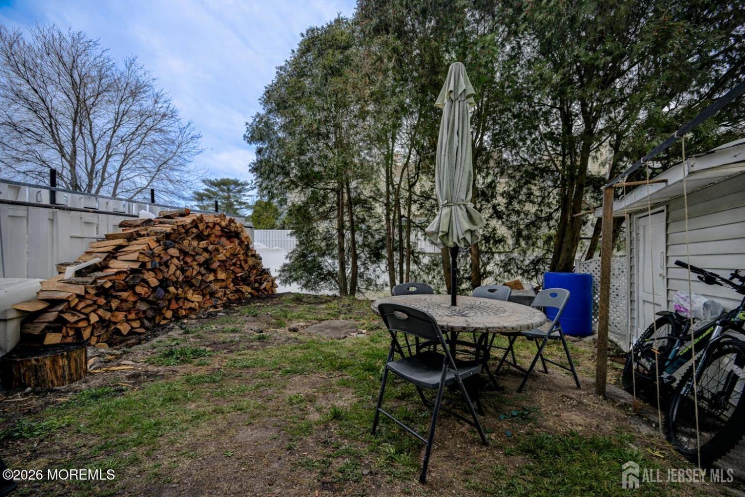 22 Borell Square Parlin, NJ 08859 - Photo 27 of 32 a view of a back yard of the house with a table and chairs