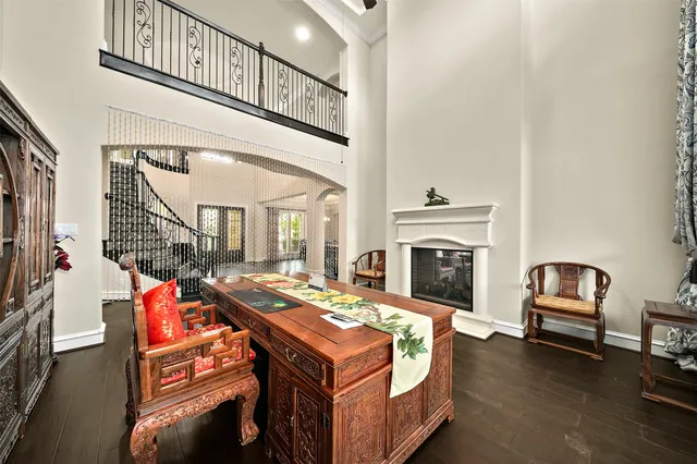 a living room with furniture pool table flat screen tv and a fireplace
