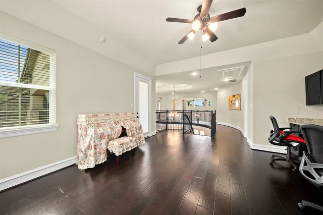 a view of livingroom with furniture hardwood floor and a ceiling fan