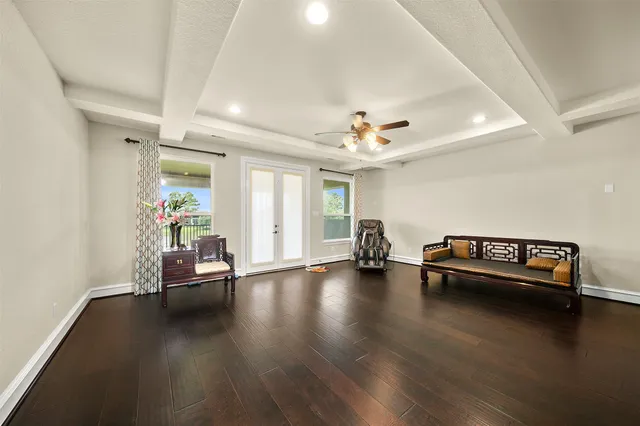 a view of a room with wooden floor and gym equipment