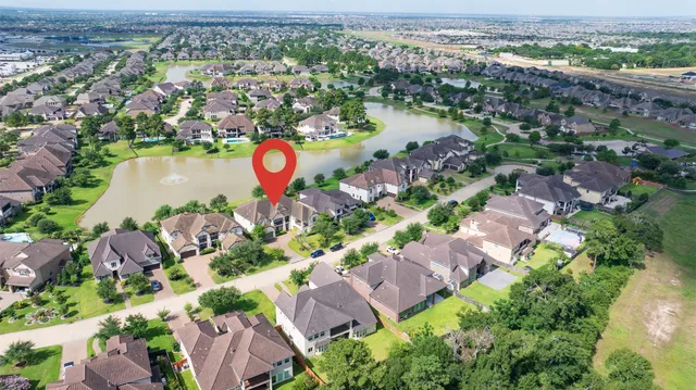 an aerial view of residential houses with outdoor space and swimming pool