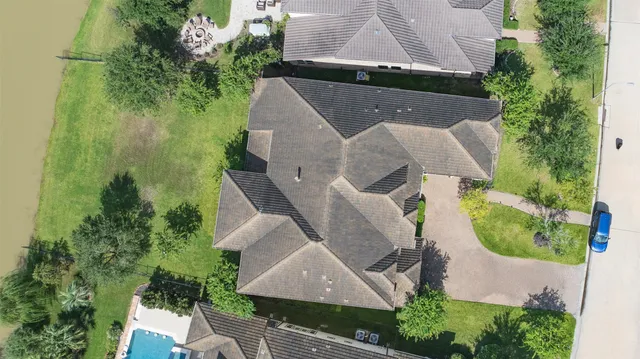 an aerial view of a house with garden space and street view