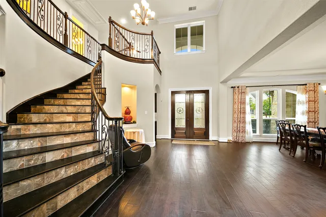 a view of entryway and hall with wooden floor
