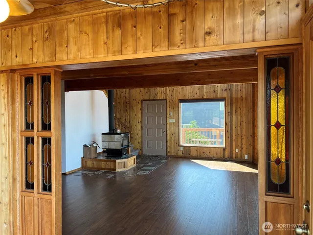 a living room with a wooden floor and a fireplace