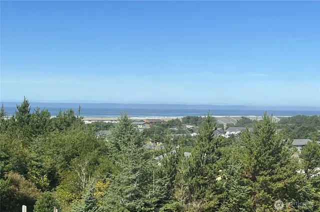 an aerial view of a houses with a yard