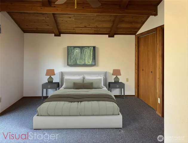 a bedroom with a bed window and a table