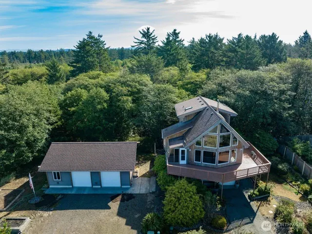 a aerial view of a house next to a yard