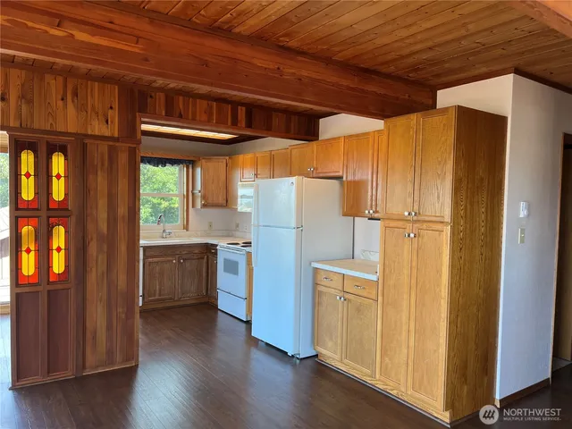 a view of a refrigerator and wooden floor