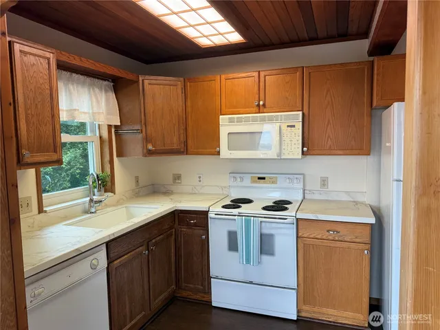 a kitchen with a sink stove and microwave