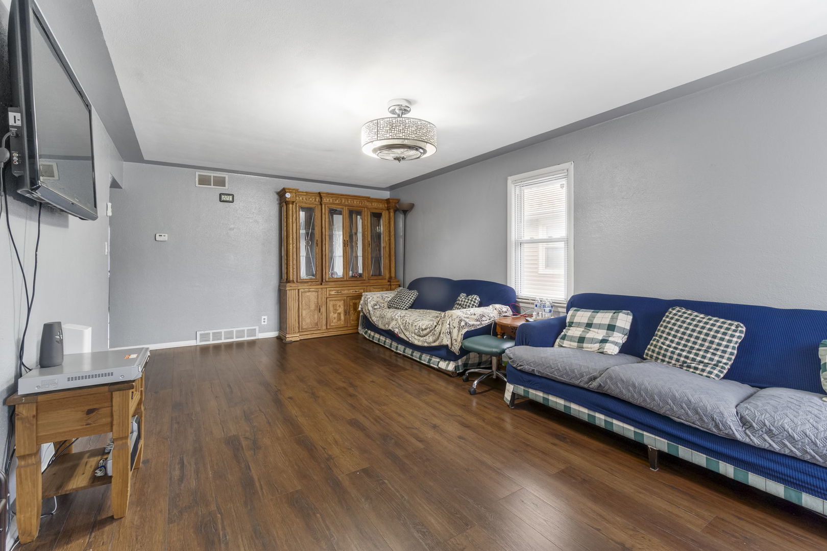 208 South Reed Street Joliet, IL 60436 - Photo 4 of 18 a living room with furniture and a wooden floor
