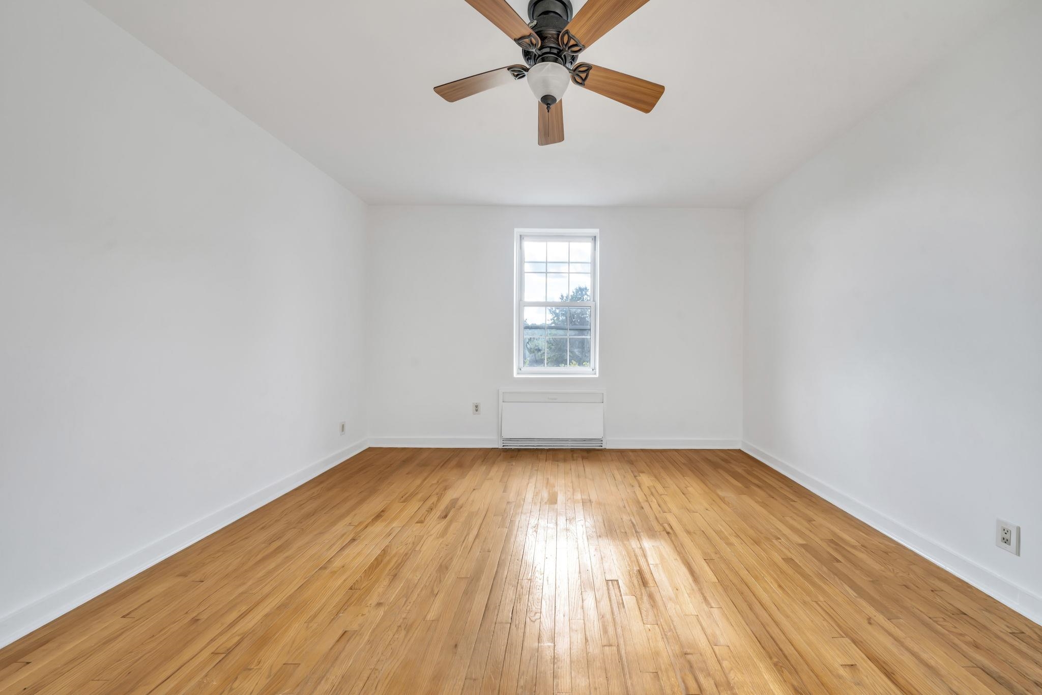8450 Boulevard East, Unit 4F North Bergen, NJ 07047 - Photo 16 of 22 wooden floor in an empty room with a window