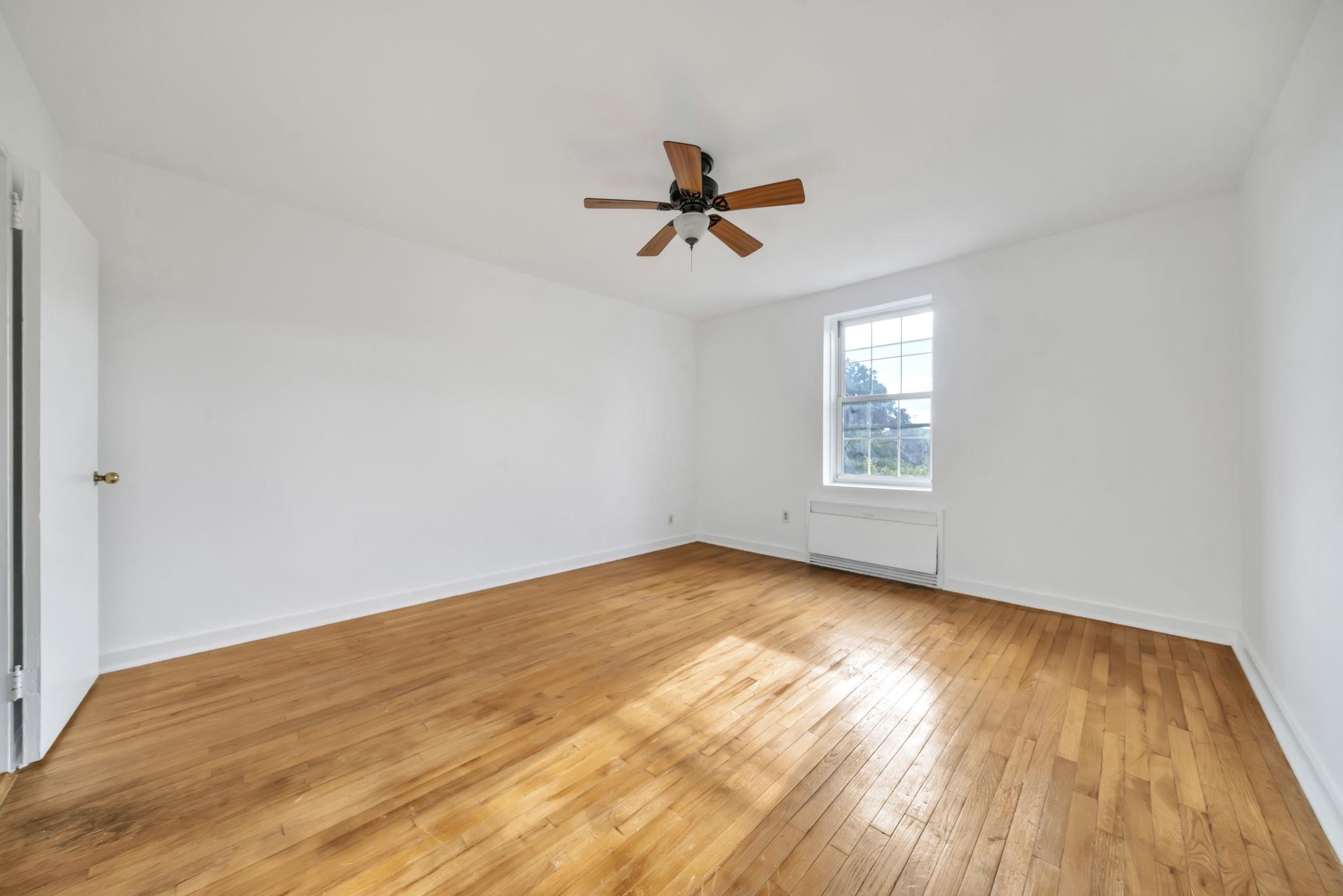 8450 Boulevard East, Unit 4F North Bergen, NJ 07047 - Photo 17 of 22 wooden floor in an empty room with a window