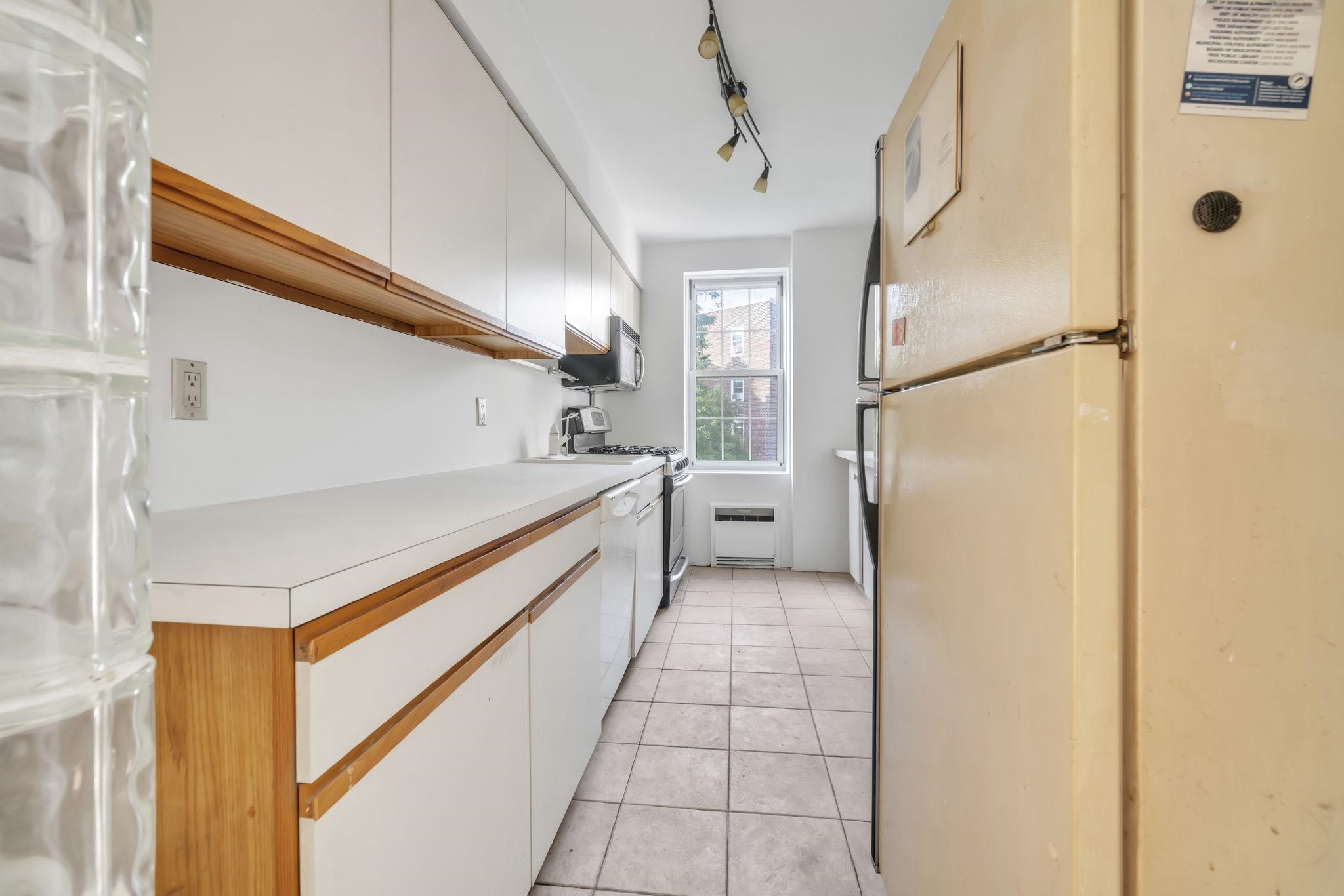 8450 Boulevard East, Unit 4F North Bergen, NJ 07047 - Photo 7 of 22 a kitchen with stainless steel appliances granite countertop a refrigerator and a stove