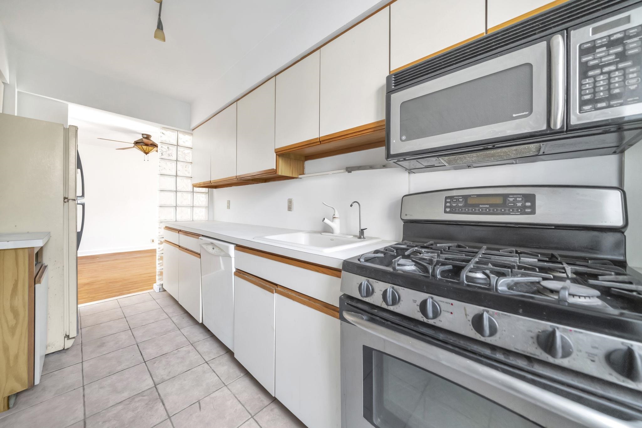 8450 Boulevard East, Unit 4F North Bergen, NJ 07047 - Photo 9 of 22 a kitchen with stainless steel appliances granite countertop a stove and a refrigerator