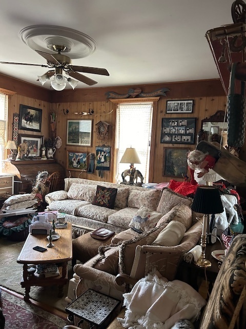2665 East Sherrill Road Minooka, IL 60447 - Photo 15 of 23 a living room with furniture a chandelier and a window