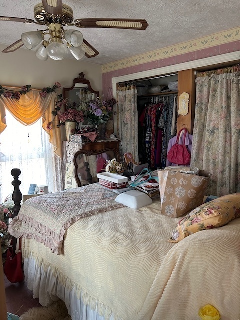 2665 East Sherrill Road Minooka, IL 60447 - Photo 21 of 23 a bed room with a bed and a walk in closet