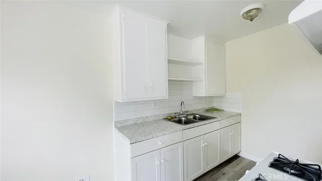 a kitchen that has a sink and a stove