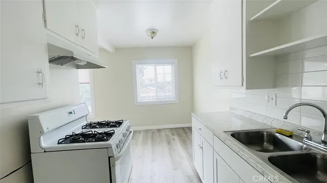 a kitchen with a sink and cabinets