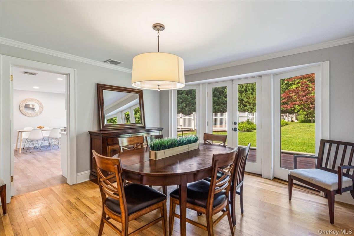 130 Sands Point Road Sands Point, NY 11050 - Photo 11 of 26 Dining room featuring french doors, light wood finished floors, and ornamental molding