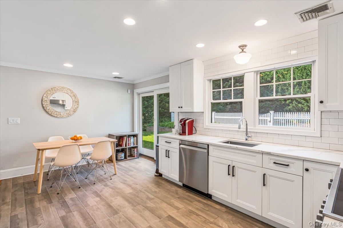 130 Sands Point Road Sands Point, NY 11050 - Photo 12 of 26 Kitchen featuring dishwasher, a sink, backsplash, white cabinets, and recessed lighting
