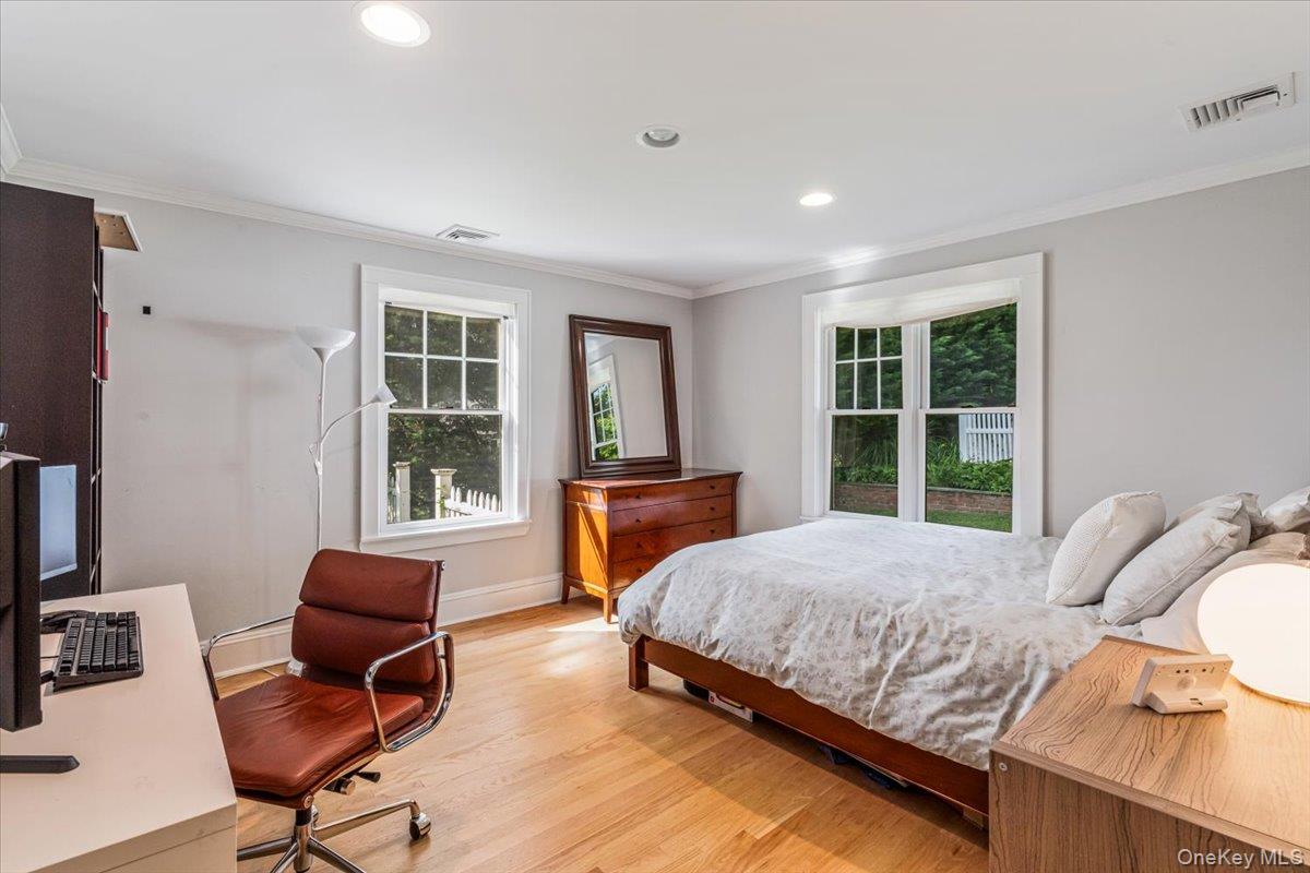 130 Sands Point Road Sands Point, NY 11050 - Photo 16 of 26 Bedroom featuring light wood-style flooring, ornamental molding, a desk, baseboards, and recessed lighting