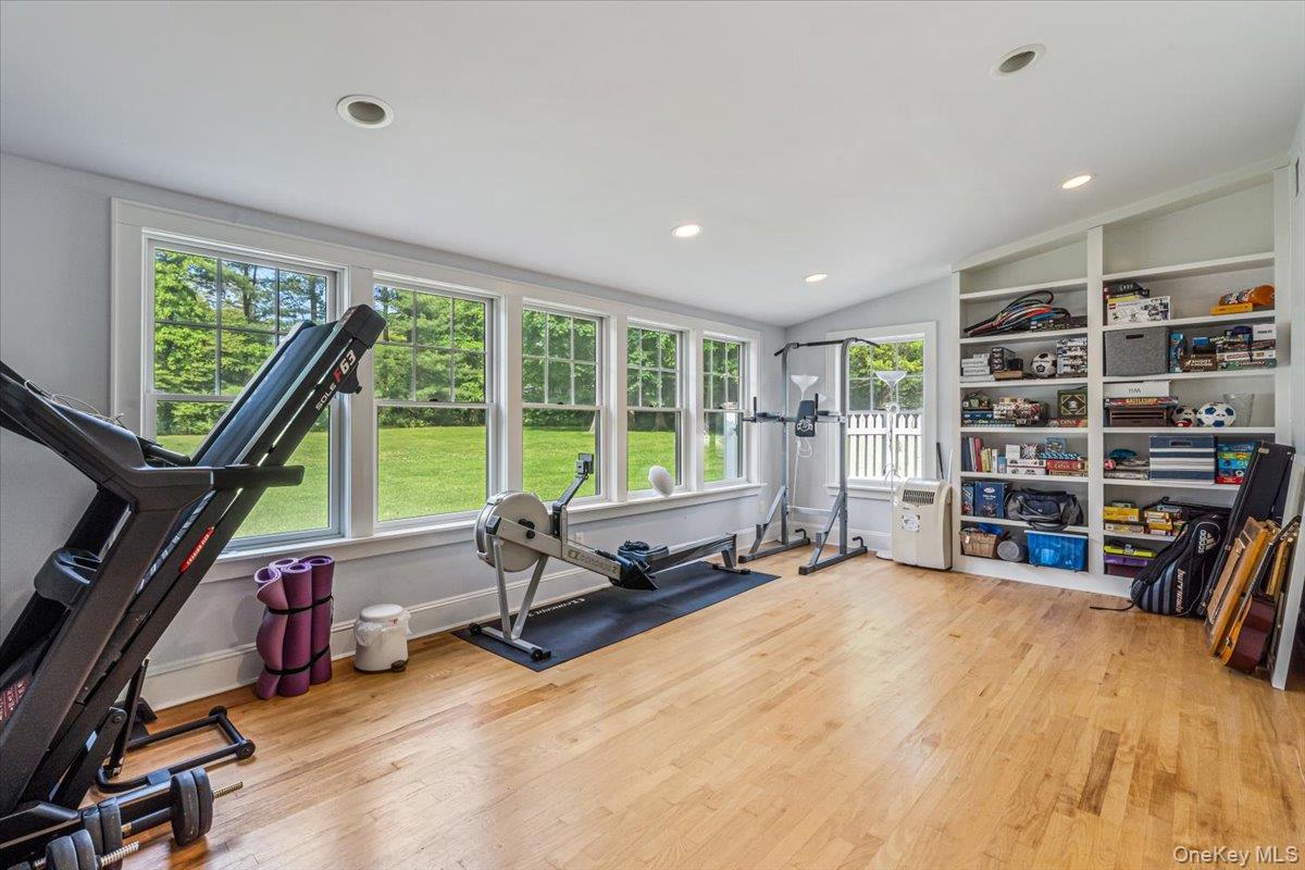 130 Sands Point Road Sands Point, NY 11050 - Photo 22 of 26 Workout room with wood finished floors, vaulted ceiling, and recessed lighting