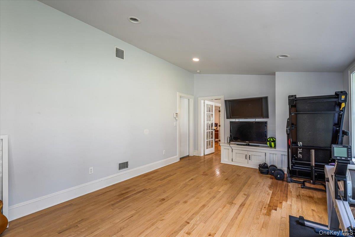 130 Sands Point Road Sands Point, NY 11050 - Photo 23 of 26 Unfurnished living room with light wood-style floors, baseboards, and recessed lighting