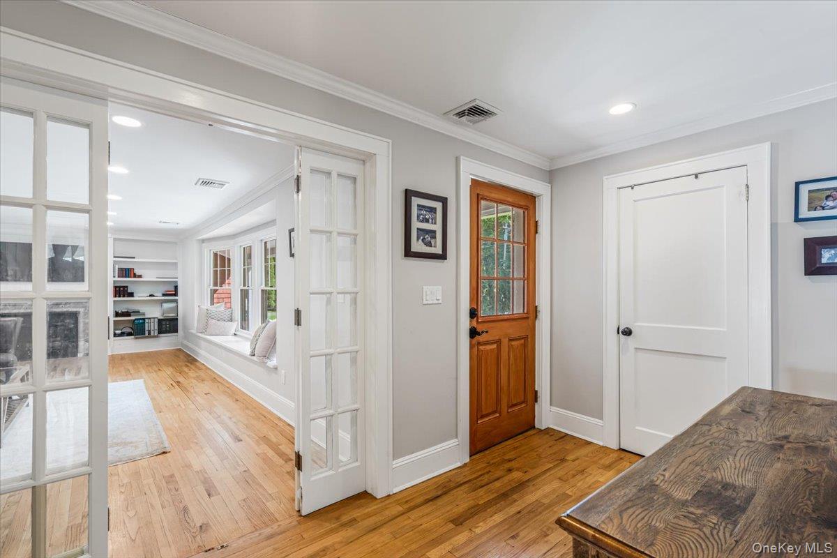 130 Sands Point Road Sands Point, NY 11050 - Photo 5 of 26 Entryway with light wood-style flooring, ornamental molding, baseboards, and recessed lighting