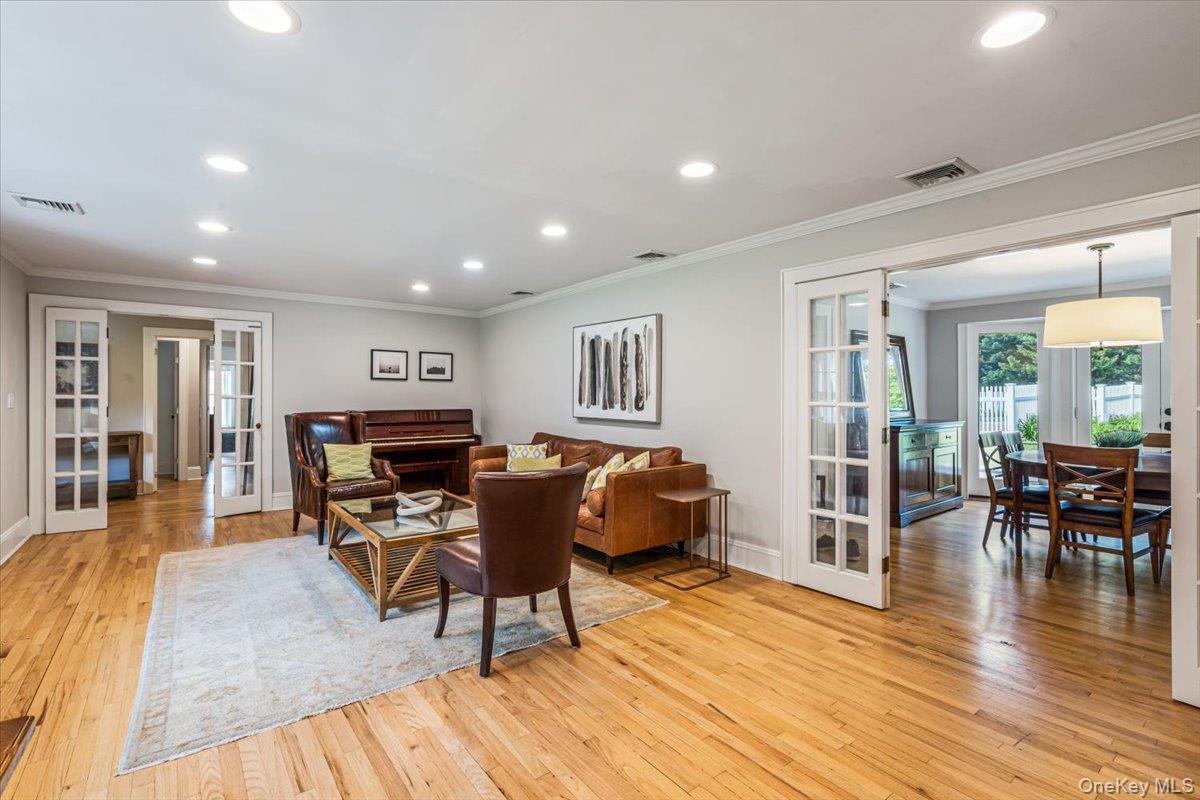 130 Sands Point Road Sands Point, NY 11050 - Photo 8 of 26 Dining room with french doors, light wood finished floors, recessed lighting, and ornamental molding