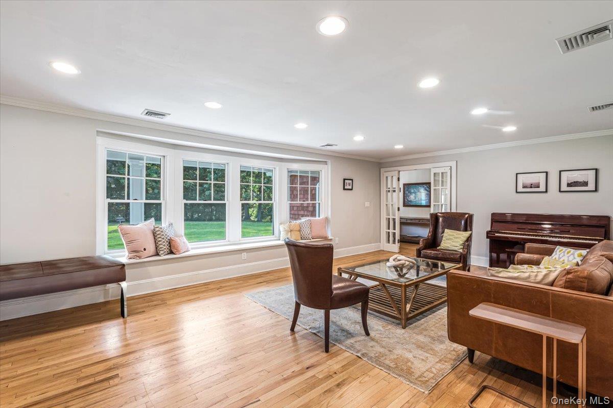 130 Sands Point Road Sands Point, NY 11050 - Photo 9 of 26 Living room with ornamental molding, recessed lighting, light wood-type flooring, and baseboards