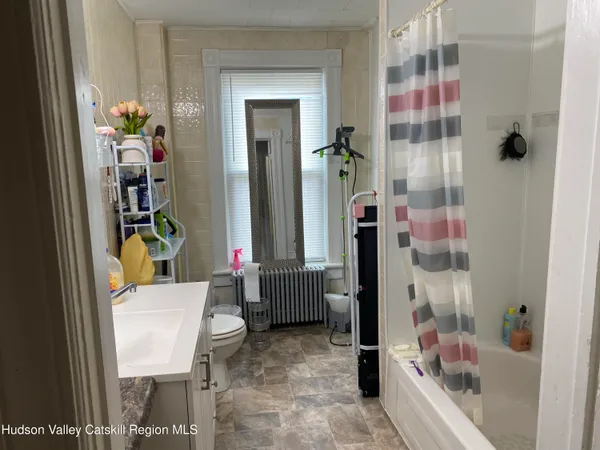 a bathroom with a bathtub shower and a sink