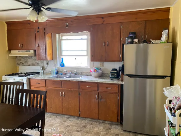 a white refrigerator freezer sitting inside of a kitchen