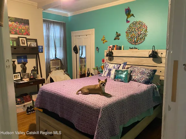 a bedroom with furniture and a flat screen tv