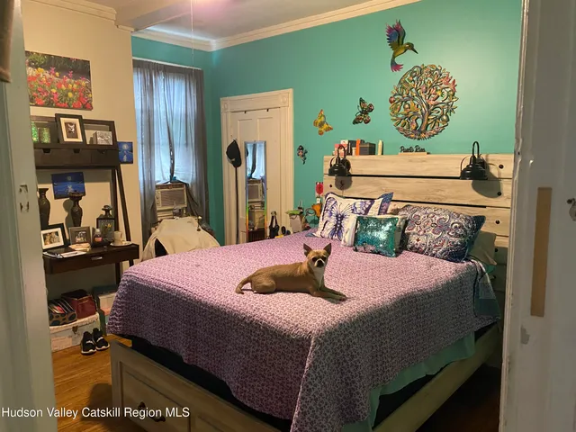 a bedroom with furniture and a flat screen tv
