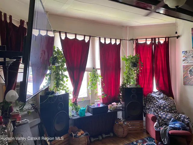 a living room with lots of furniture and clutter