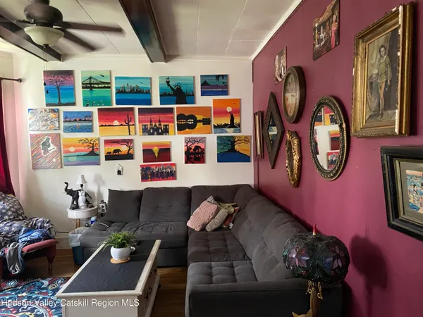 a living room with patio furniture and a chandelier