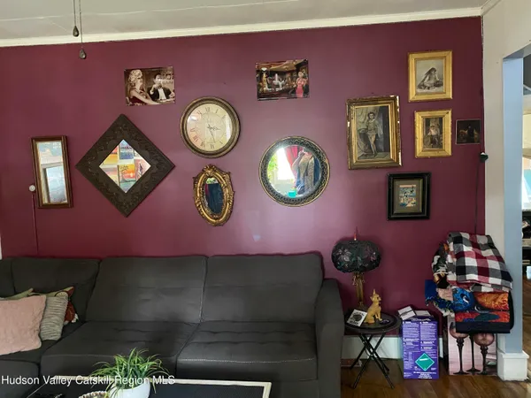 a room with lots of white furniture and a flat screen tv