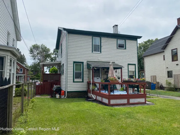 a front view of house with a garden and patio