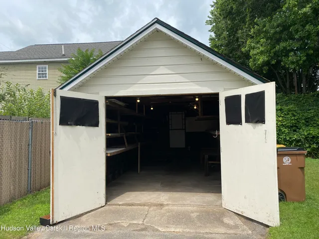 a view of small white house with a small yard